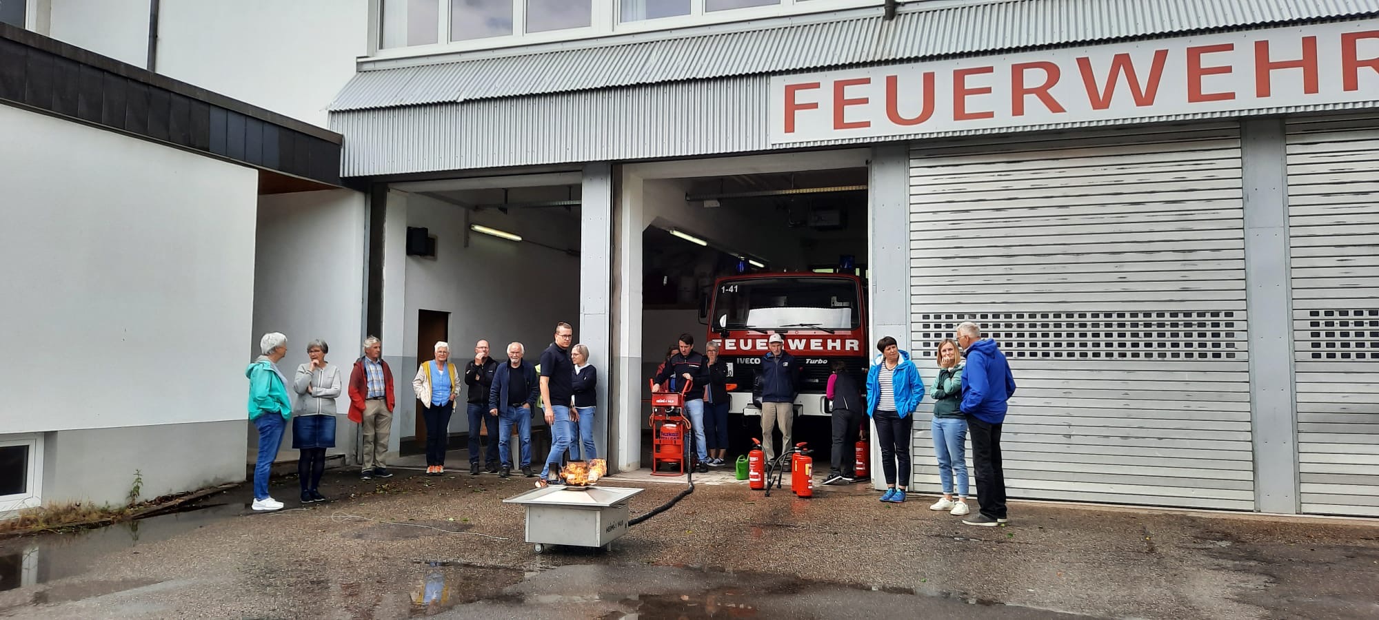 Teilnehmerinnen und Teilnehmer beim Kurs „Was tun im Brandfall“ mit Georg Schilli und der Feuerwehr Schonach vor dem Feuerwehrgerätehaus